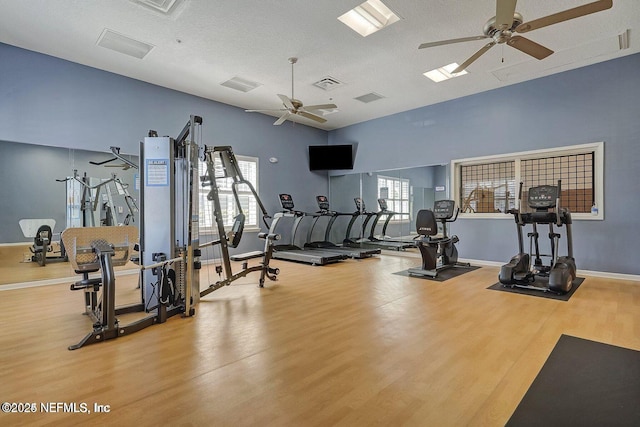 workout area with plenty of natural light, wood finished floors, and visible vents