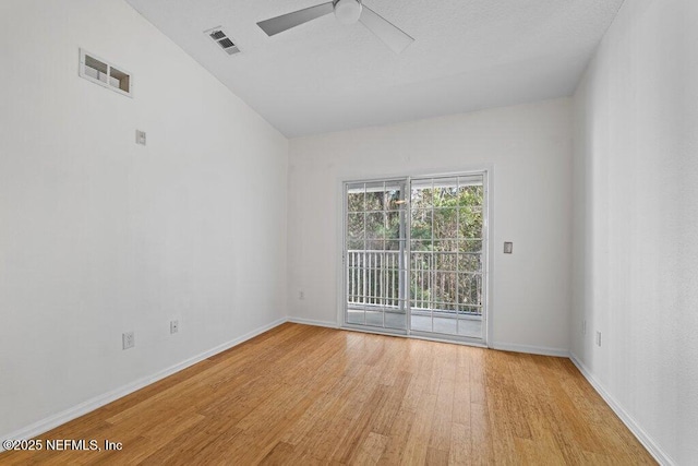 empty room featuring light wood-type flooring, ceiling fan, visible vents, and baseboards