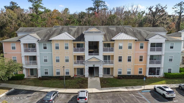 view of building exterior featuring uncovered parking