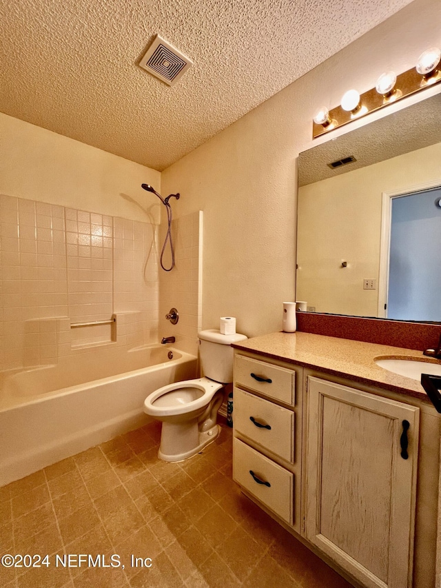 full bathroom with vanity, a textured ceiling,  shower combination, and toilet