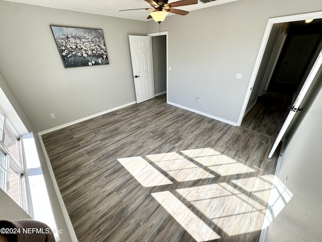 empty room featuring ceiling fan, hardwood / wood-style floors, and a textured ceiling