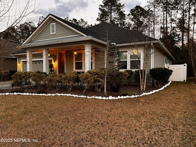 bungalow featuring an attached garage and a front yard