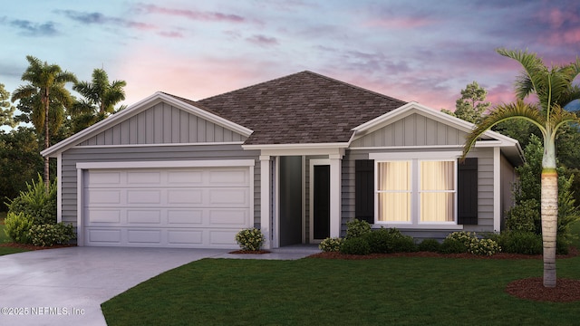 view of front facade with a yard and a garage