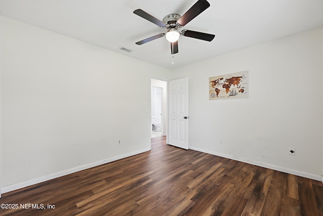 unfurnished room with dark hardwood / wood-style flooring and ceiling fan