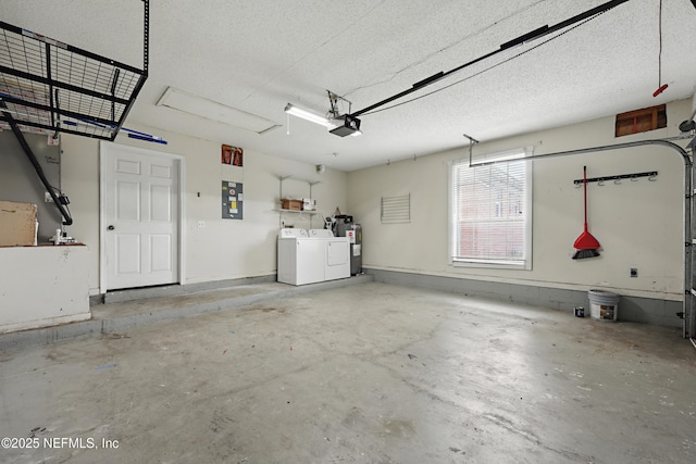 garage with a garage door opener, electric water heater, washing machine and clothes dryer, and electric panel