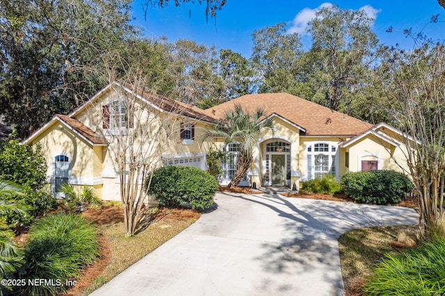 mediterranean / spanish home featuring a garage