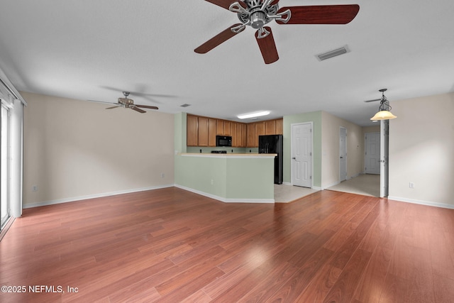 unfurnished living room featuring light hardwood / wood-style flooring and ceiling fan