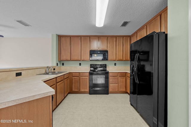 kitchen with sink, black appliances, kitchen peninsula, and a textured ceiling