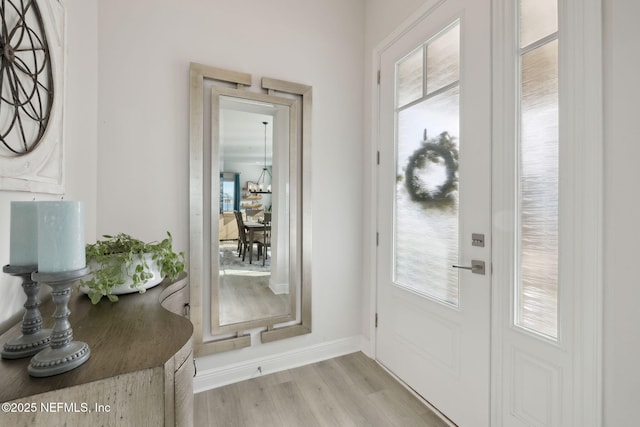 entryway with light wood-type flooring and baseboards