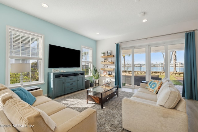 living room featuring recessed lighting and a textured ceiling