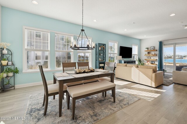 dining room with recessed lighting, light wood-type flooring, and baseboards