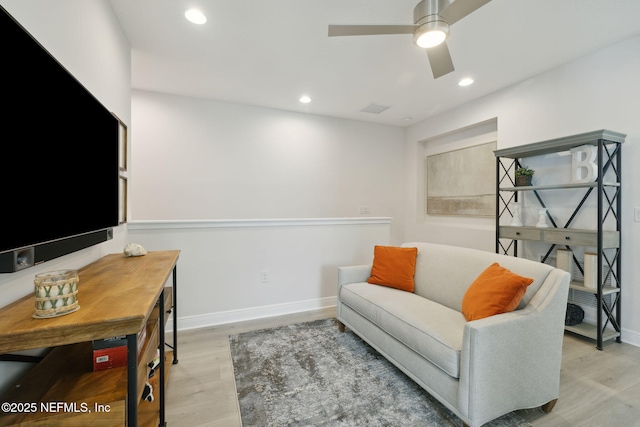 sitting room featuring recessed lighting, baseboards, and light wood finished floors