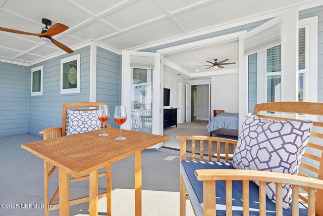 sunroom / solarium with coffered ceiling and ceiling fan