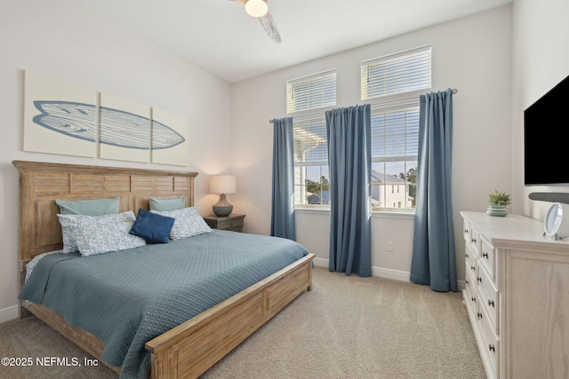 bedroom with ceiling fan, baseboards, and light carpet