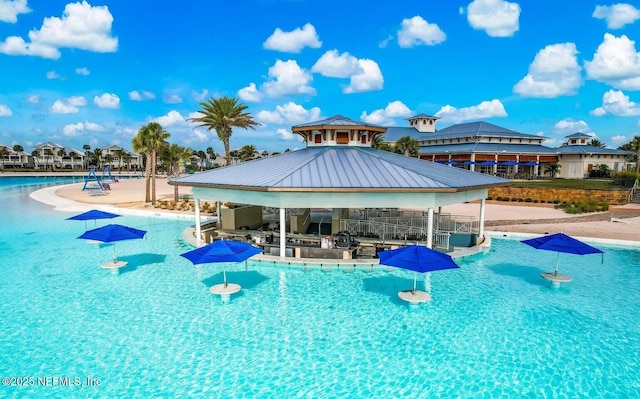 community pool featuring a gazebo and a patio area