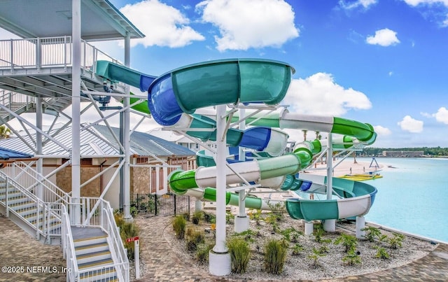 view of home's community with stairway and a water view