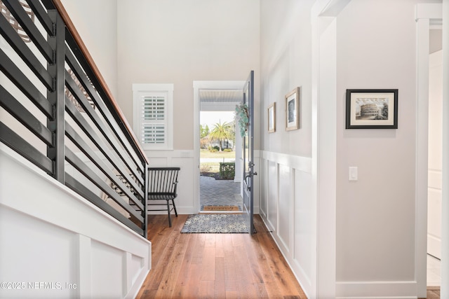 foyer with light hardwood / wood-style floors and a high ceiling