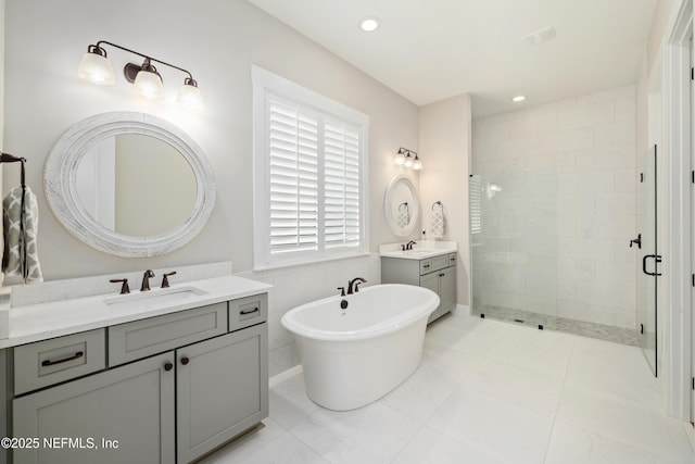 bathroom featuring vanity and separate shower and tub