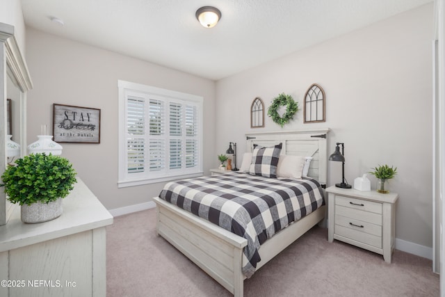 bedroom featuring light carpet