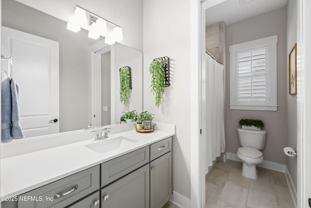 bathroom featuring vanity, tile patterned flooring, and toilet