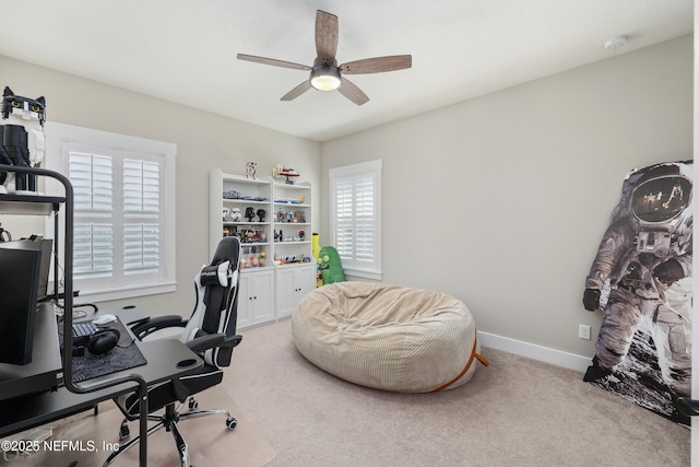 carpeted office space with ceiling fan