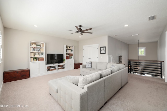 living room with ceiling fan and light carpet