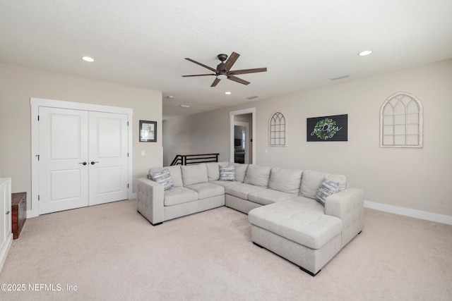 carpeted living room with a textured ceiling and ceiling fan