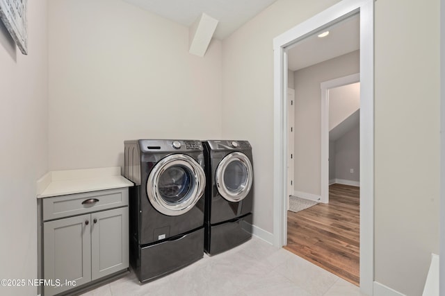 laundry area featuring separate washer and dryer and light hardwood / wood-style floors