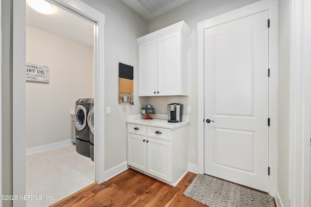 laundry room featuring light hardwood / wood-style flooring and washer and dryer