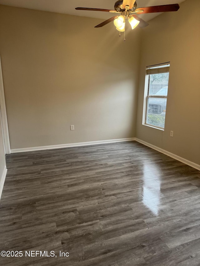 unfurnished room with ceiling fan and dark hardwood / wood-style flooring