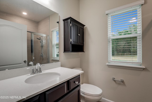 bathroom with vanity, an enclosed shower, and toilet