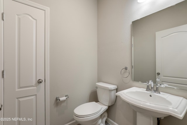 bathroom featuring sink and toilet