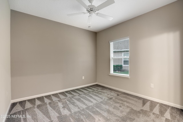 carpeted spare room with ceiling fan