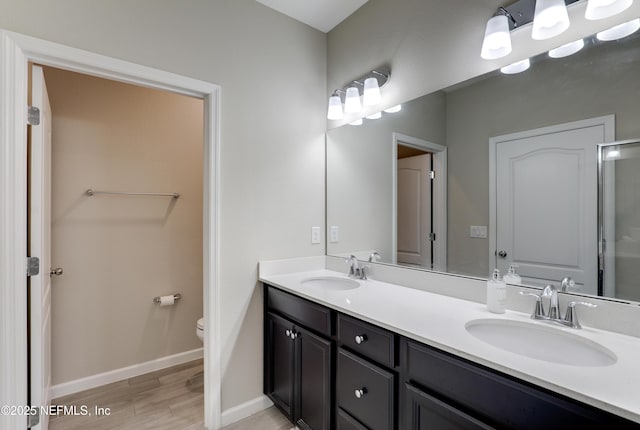 bathroom with hardwood / wood-style flooring, vanity, and toilet