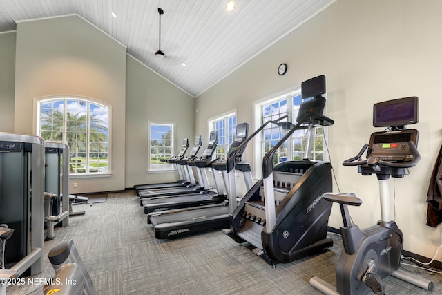 exercise room featuring wood ceiling, carpet flooring, and high vaulted ceiling