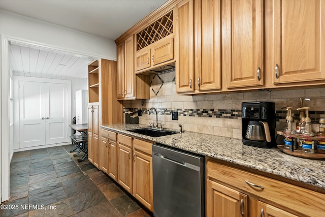 kitchen with sink, stainless steel dishwasher, light stone counters, and decorative backsplash