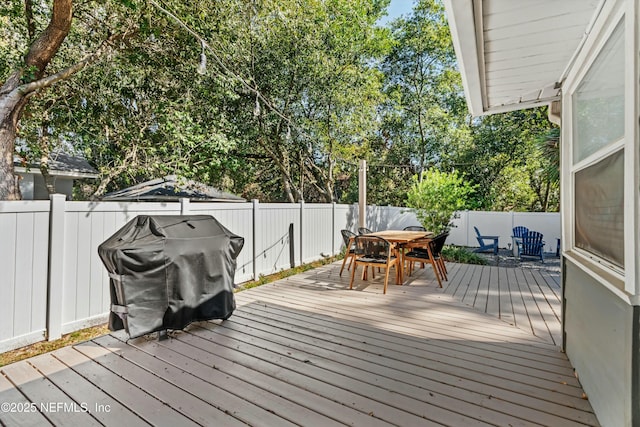 wooden terrace featuring area for grilling