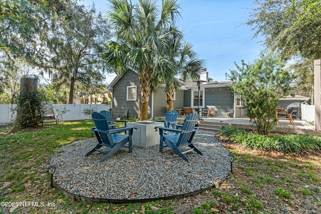 view of yard with a wooden deck and an outdoor fire pit