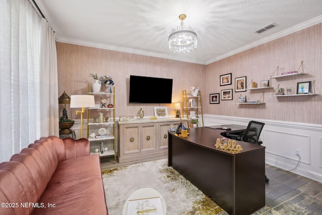 office with wallpapered walls, visible vents, a wainscoted wall, light wood-style flooring, and a notable chandelier