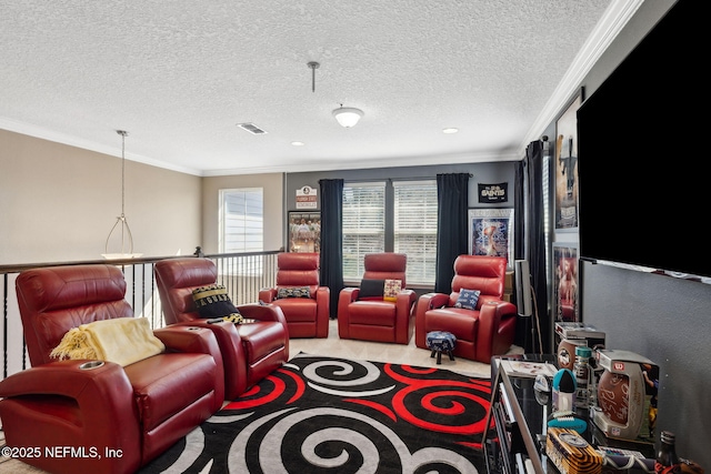 home theater room with visible vents, ornamental molding, a textured ceiling, and light colored carpet