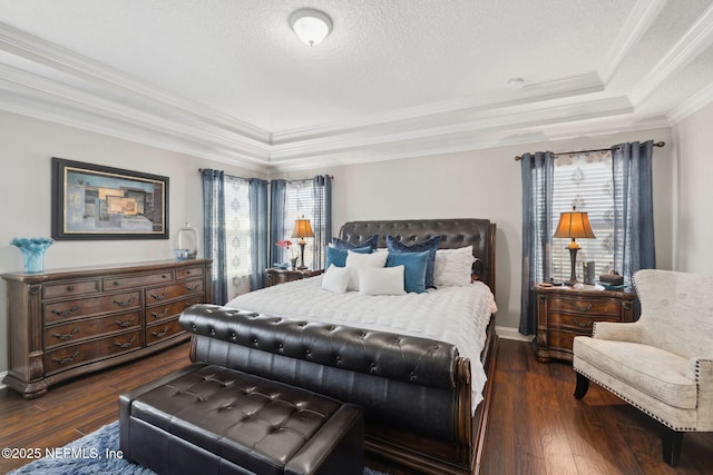 bedroom featuring a textured ceiling, dark wood-type flooring, a raised ceiling, and crown molding