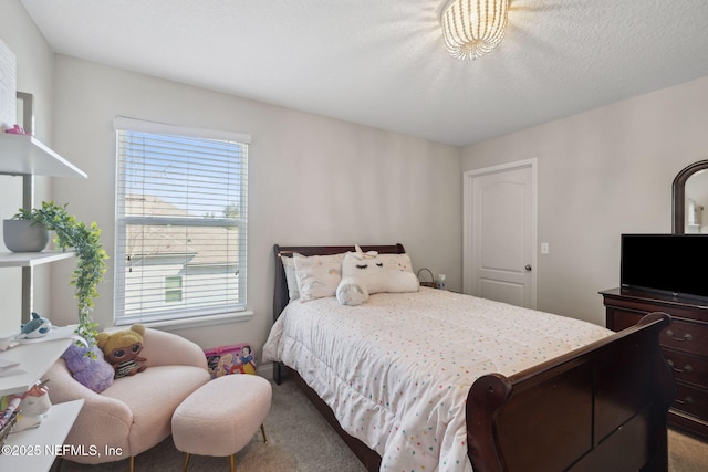 bedroom featuring carpet floors and a textured ceiling