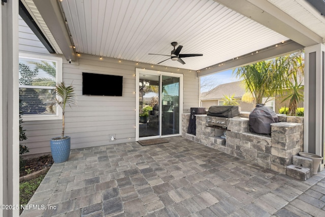 view of patio / terrace with grilling area, an outdoor kitchen, and a ceiling fan