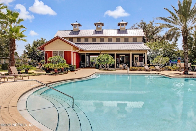 community pool featuring a patio area and fence