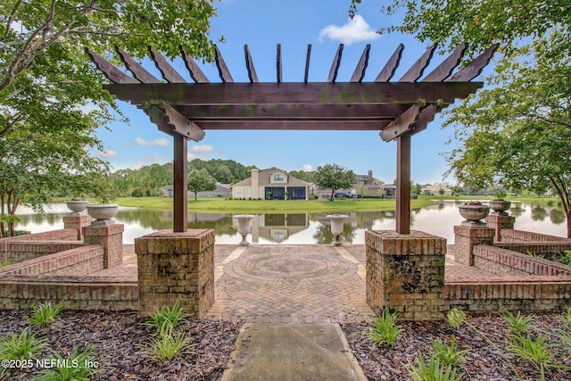 view of patio featuring a water view and a pergola