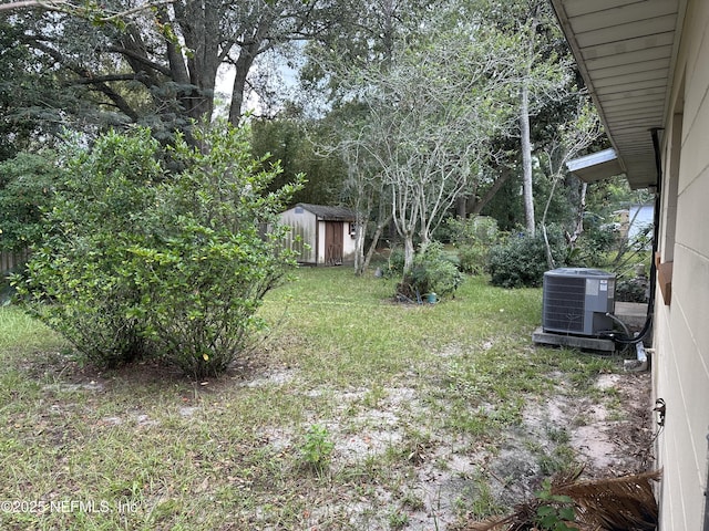 view of yard featuring a storage unit and central air condition unit