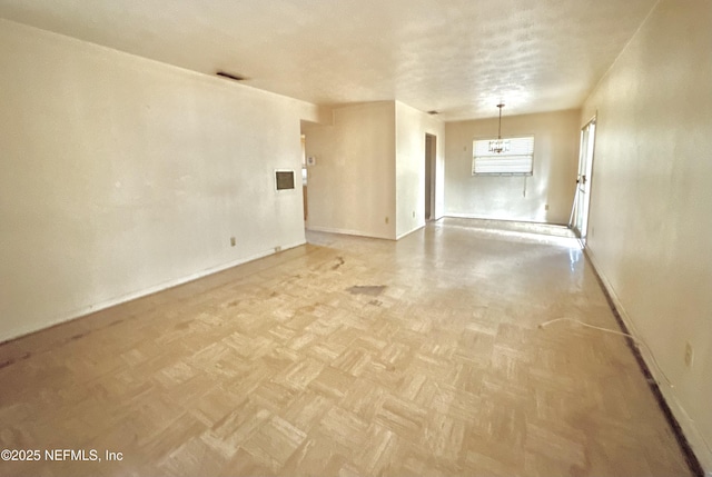 empty room featuring light parquet floors and a textured ceiling