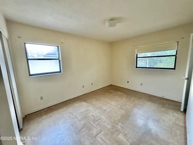 unfurnished bedroom featuring light parquet flooring