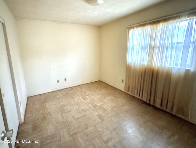 unfurnished room featuring light parquet floors