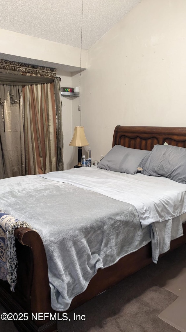 carpeted bedroom with a textured ceiling